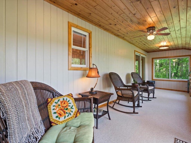 15473 Wilderness Trl, Crosslake, MN 56442 - living area featuring wooden ceiling, a ceiling fan, carpet floors, wooden walls, and vaulted ceiling