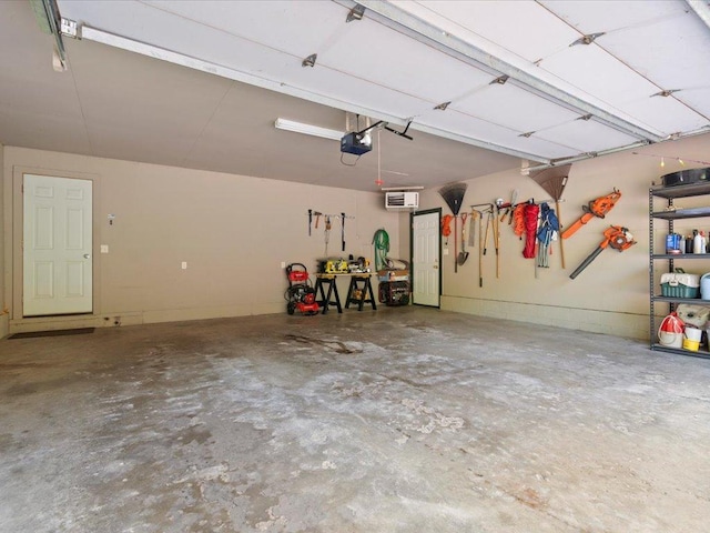 15473 Wilderness Trl, Crosslake, MN 56442 - garage with an AC wall unit and a garage door opener
