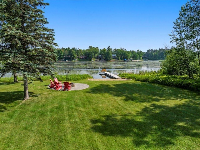 15473 Wilderness Trl, Crosslake, MN 56442 - view of green lawn featuring a water view, a floating dock, and a fire pit