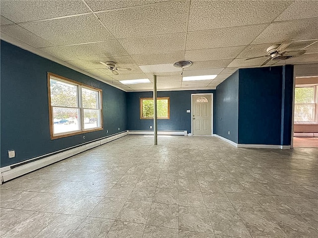 403 2nd St, Austin, MN 55912 - spare room featuring ceiling fan, a paneled ceiling, plenty of natural light, baseboards, and baseboard heating