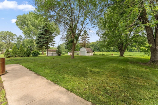 9351 Ermine Blvd NW, Ramsey, MN 55303 - view of green lawn featuring an outbuilding and a garage