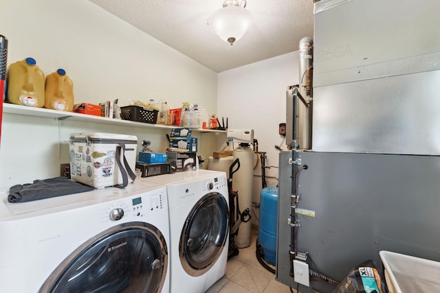 9351 Ermine Blvd NW, Ramsey, MN 55303 - laundry room featuring washing machine and dryer, heating unit, light tile patterned floors, and a textured ceiling