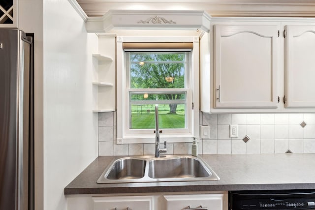 9351 Ermine Blvd NW, Ramsey, MN 55303 - kitchen featuring freestanding refrigerator, dishwashing machine, white cabinetry, and decorative backsplash
