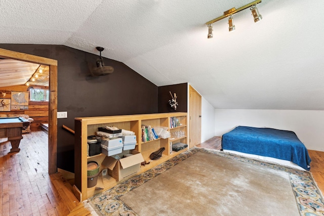 9351 Ermine Blvd NW, Ramsey, MN 55303 - bedroom with hardwood / wood-style floors, lofted ceiling, and a textured ceiling