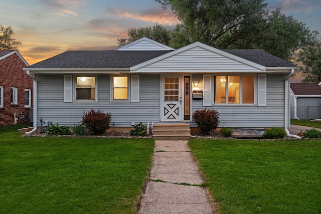 2101 6th Ave NE, Austin, MN 55912 - bungalow-style home with a lawn and a shingled roof