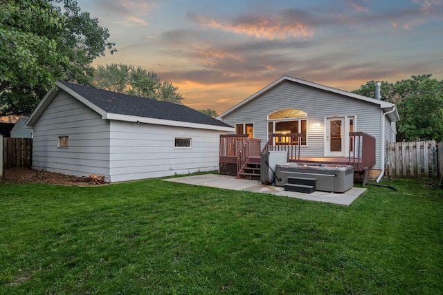 2101 6th Ave NE, Austin, MN 55912 - back of property at dusk with a deck, a patio, and an outbuilding