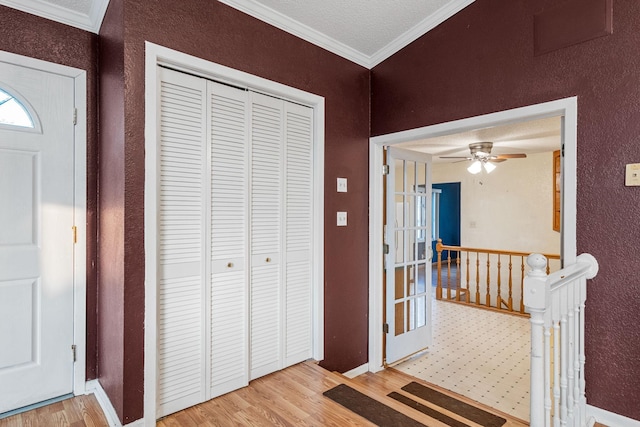 2101 6th Ave NE, Austin, MN 55912 - entrance foyer featuring wood finished floors, crown molding, baseboards, and a ceiling fan