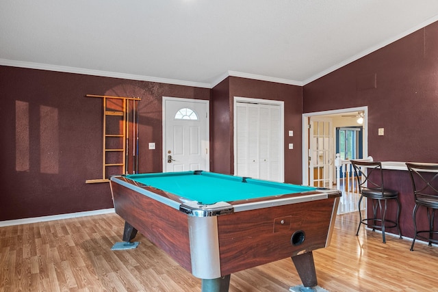 2101 6th Ave NE, Austin, MN 55912 - recreation room with light wood-style flooring, billiards table, baseboards, crown molding, and a dry bar