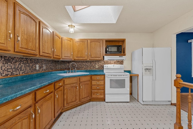 2101 6th Ave NE, Austin, MN 55912 - kitchen featuring white appliances, a sink, extractor fan, a skylight, and brown cabinetry
