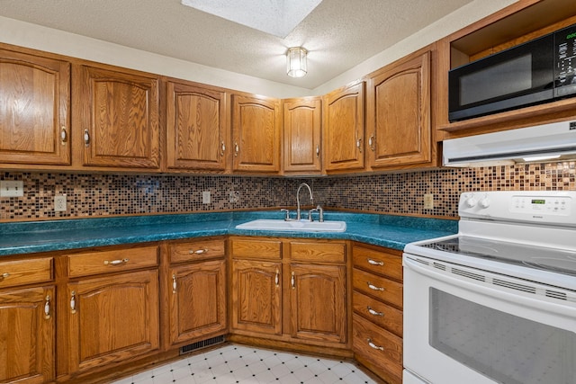 2101 6th Ave NE, Austin, MN 55912 - kitchen with white electric range oven, black microwave, a sink, brown cabinets, and a textured ceiling