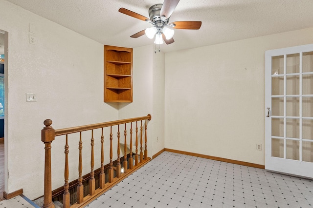 2101 6th Ave NE, Austin, MN 55912 - spare room with built in features, a ceiling fan, a textured ceiling, baseboards, and light floors
