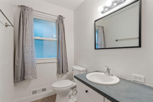 2101 6th Ave NE, Austin, MN 55912 - bathroom with vanity, toilet, and wood finished floors