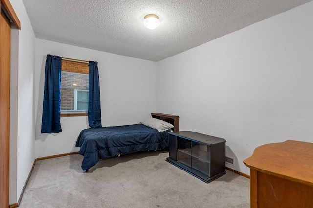 2101 6th Ave NE, Austin, MN 55912 - bedroom featuring carpet flooring, baseboards, and a textured ceiling