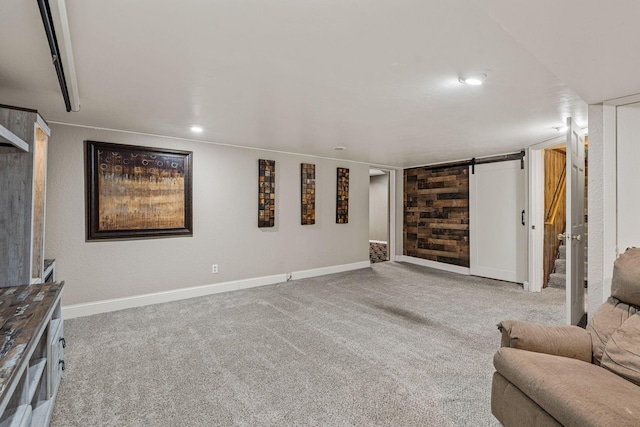2101 6th Ave NE, Austin, MN 55912 - living room with carpet flooring, baseboards, and a barn door