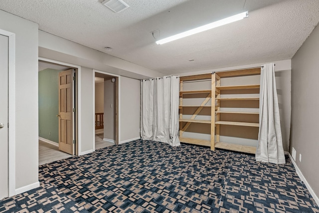 2101 6th Ave NE, Austin, MN 55912 - finished below grade area featuring carpet, a textured ceiling, and baseboards