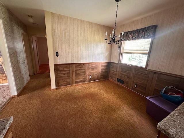 21 Glen Cir, Babbitt, MN 55706 - dining space with a chandelier, carpet flooring, wallpapered walls, a wainscoted wall, and wood walls