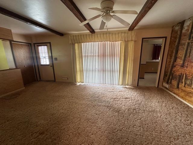 21 Glen Cir, Babbitt, MN 55706 - unfurnished living room with beam ceiling, a ceiling fan, and carpet floors