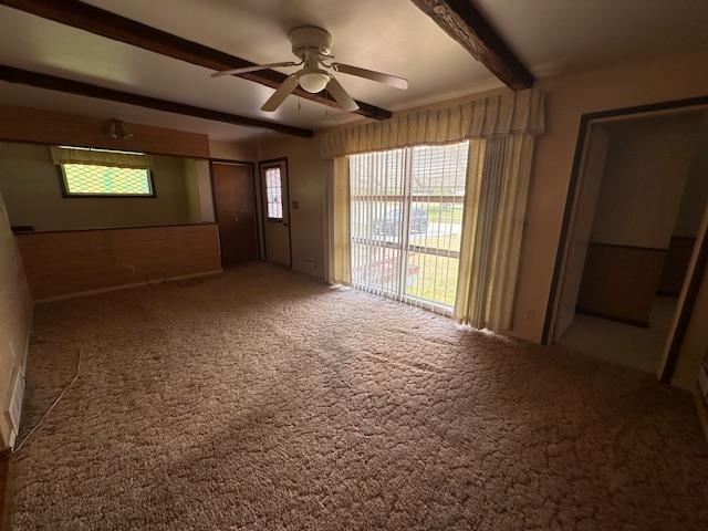 21 Glen Cir, Babbitt, MN 55706 - empty room with beam ceiling, carpet flooring, and a ceiling fan