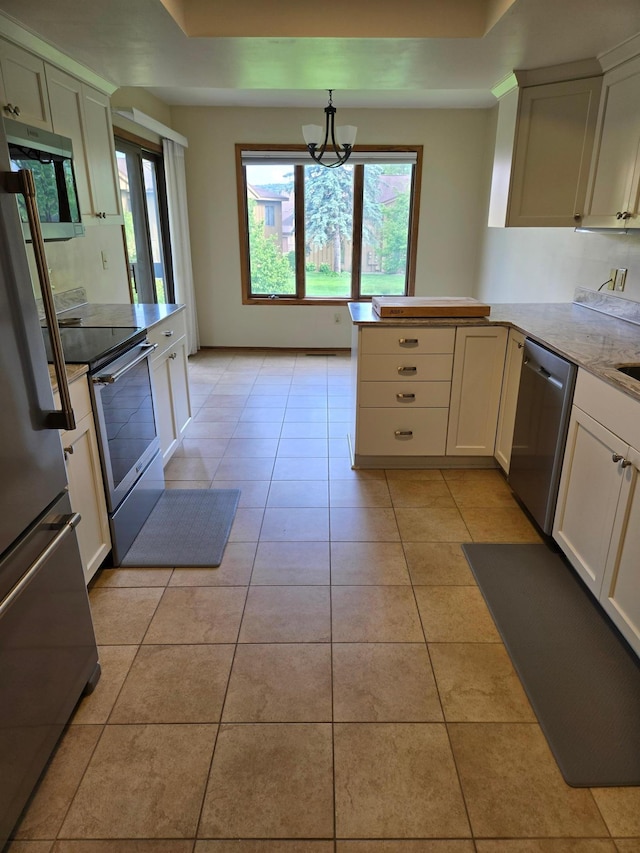 1924 Greenfield Ln SW Unit 201, Rochester, MN 55902 - kitchen featuring appliances with stainless steel finishes, a peninsula, a chandelier, light tile patterned flooring, and decorative light fixtures