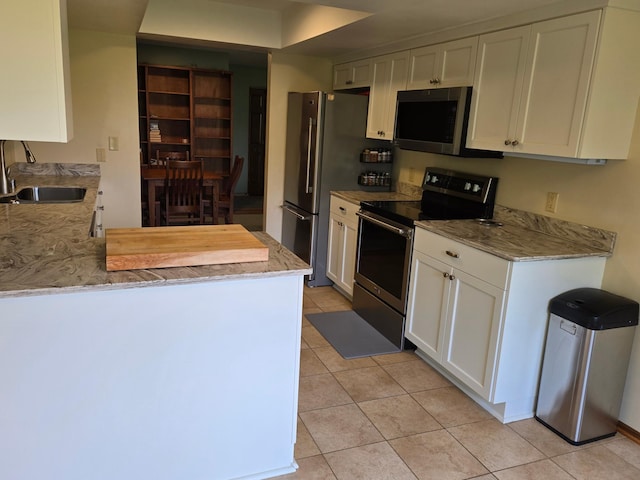 1924 Greenfield Ln SW Unit 201, Rochester, MN 55902 - kitchen with appliances with stainless steel finishes, a sink, light tile patterned flooring, white cabinets, and light stone counters