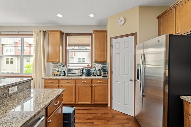 1949 Commonwealth Blvd Unit 2, Chanhassen, MN 55317 - kitchen with stainless steel fridge, dark wood-style floors, backsplash, brown cabinets, and recessed lighting