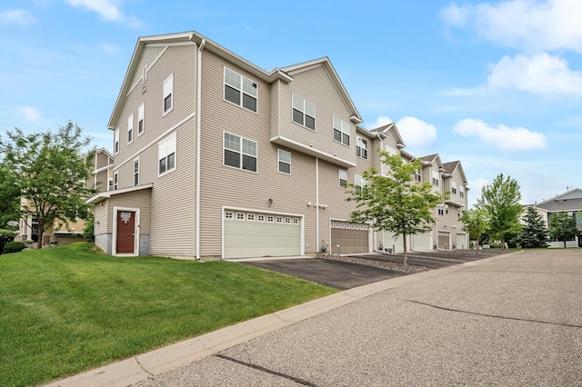 1949 Commonwealth Blvd Unit 2, Chanhassen, MN 55317 - view of building exterior featuring a garage, asphalt driveway, and a residential view