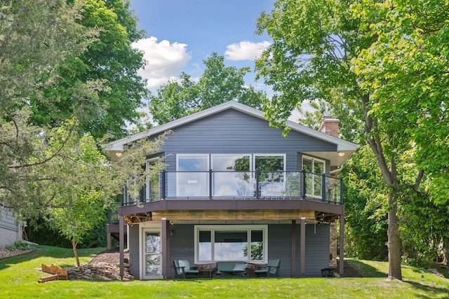4450 Forest Lake Lndg, Orono, MN 55364 - rear view of house with a wooden deck, a chimney, and a lawn