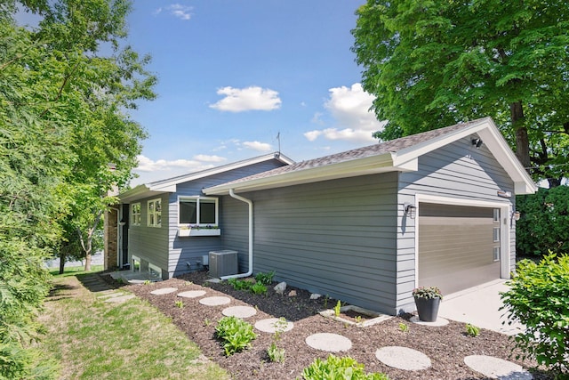 4450 Forest Lake Lndg, Orono, MN 55364 - view of side of property with a central air condition unit and a shingled roof