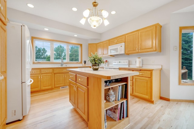 21233 Pierce St NE, East Bethel, MN 55011 - kitchen featuring white appliances, light countertops, healthy amount of natural light, a chandelier, and recessed lighting