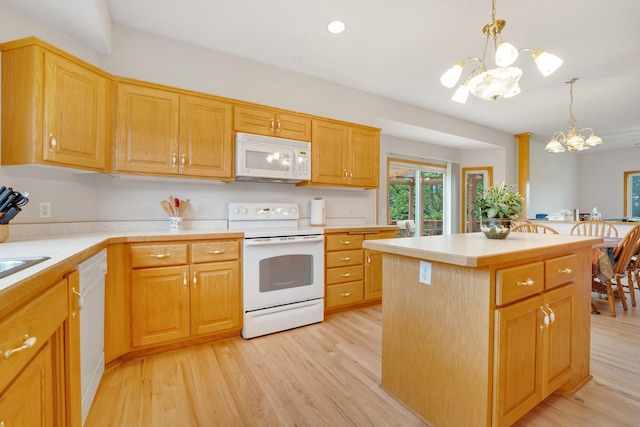 21233 Pierce St NE, East Bethel, MN 55011 - kitchen with white appliances, a chandelier, light wood-type flooring, and light countertops