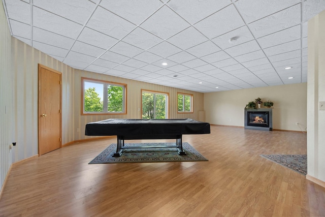 21233 Pierce St NE, East Bethel, MN 55011 - recreation room with wood finished floors, a glass covered fireplace, a drop ceiling, and pool table