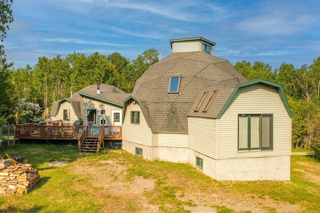 3382 Breezy Point Rd, Greenwood Twp, MN 55790 - rear view of house featuring a gambrel roof, a wooden deck, and a yard