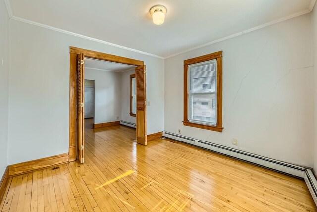 774 Capitol Hts, Saint Paul, MN 55103 - empty room featuring baseboard heating, a baseboard heating unit, light wood-style floors, and crown molding
