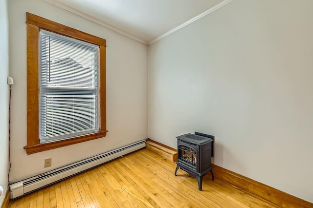 774 Capitol Hts, Saint Paul, MN 55103 - unfurnished room featuring a baseboard radiator, a wood stove, ornamental molding, and light wood-style flooring