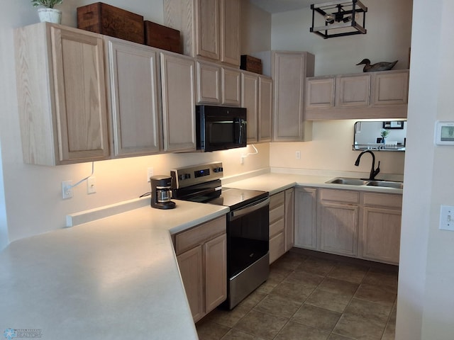 3307 38th St S, Moorhead, MN 56560 - kitchen featuring stainless steel electric range oven, black microwave, a sink, light countertops, and dark tile patterned floors