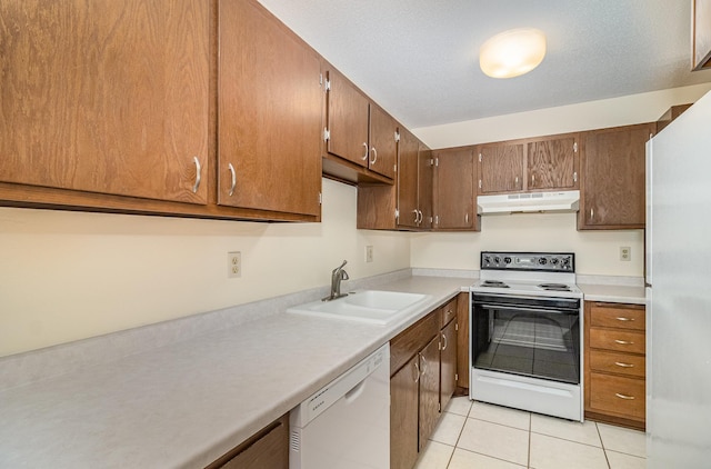 7880 Rimbley Rd, Woodbury, MN 55125 - kitchen featuring white appliances, under cabinet range hood, light tile patterned floors, and light countertops