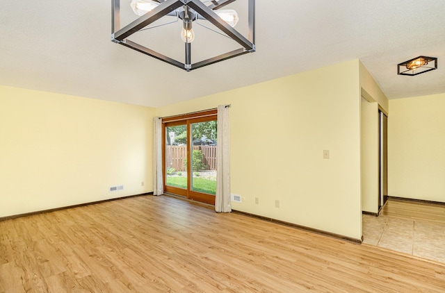 7880 Rimbley Rd, Woodbury, MN 55125 - spare room with light wood-style floors and baseboards