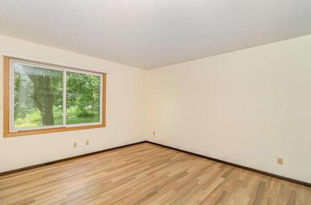 7880 Rimbley Rd, Woodbury, MN 55125 - spare room featuring light wood-type flooring and baseboards