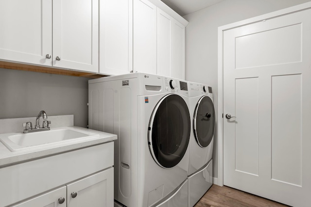 11164 184th Cir NW, Elk River, MN 55330 - washroom with independent washer and dryer, cabinet space, and light wood-type flooring