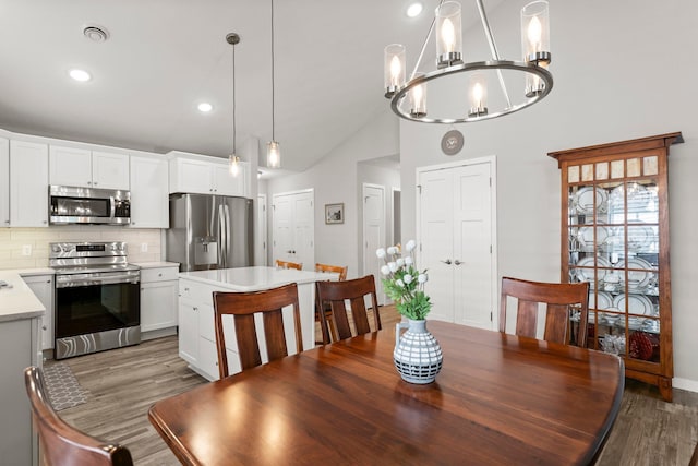 11164 184th Cir NW, Elk River, MN 55330 - dining room with wood finished floors, lofted ceiling, a chandelier, and recessed lighting