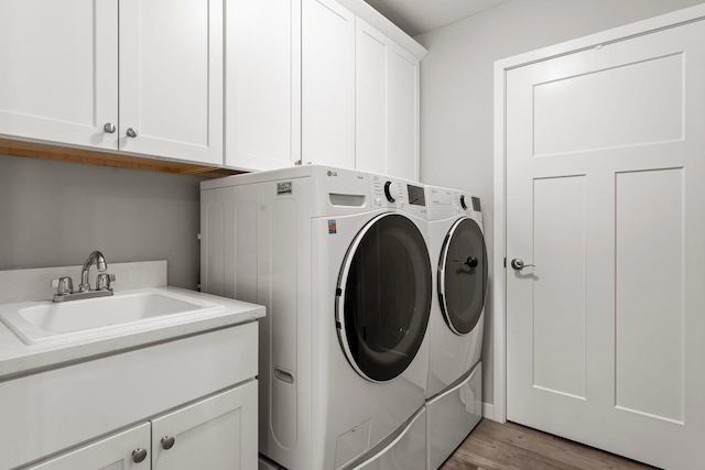 11164 184th Cir NW, Elk River, MN 55330 - washroom featuring washer and clothes dryer, cabinet space, and light wood-type flooring