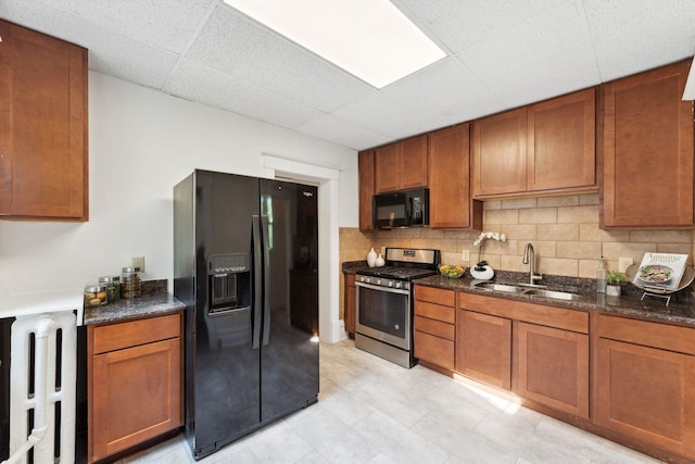 786 Iglehart Ave, Saint Paul, MN 55104 - kitchen featuring black appliances, a drop ceiling, tasteful backsplash, brown cabinets, and dark stone counters