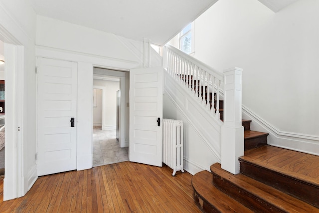 786 Iglehart Ave, Saint Paul, MN 55104 - stairway featuring radiator and wood-type flooring