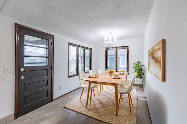 7533 16th Ave S, Richfield, MN 55423 - dining room with a chandelier, a textured ceiling, lofted ceiling, and light wood-style floors