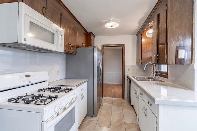 7533 16th Ave S, Richfield, MN 55423 - kitchen with white appliances, a sink, decorative backsplash, and light tile patterned floors