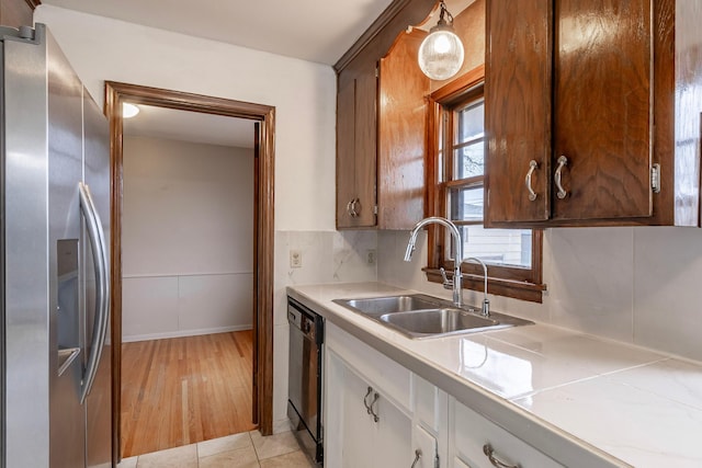 7533 16th Ave S, Richfield, MN 55423 - kitchen featuring stainless steel refrigerator with ice dispenser, a sink, black dishwasher, white cabinets, and tile counters