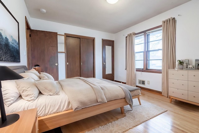 7533 16th Ave S, Richfield, MN 55423 - bedroom with light wood-type flooring, baseboards, and multiple closets