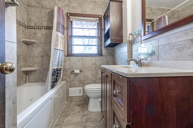 7533 16th Ave S, Richfield, MN 55423 - full bath with tile walls, toilet, vanity, shower / tub combo with curtain, and tile patterned flooring