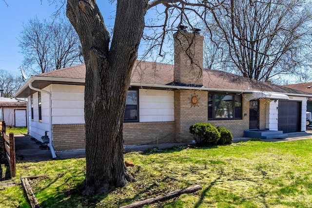 7533 16th Ave S, Richfield, MN 55423 - view of front facade featuring brick siding, a chimney, a front yard, a garage, and a shingled roof