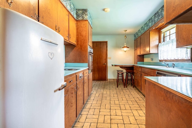 2814 Lakeview Dr, Fergus Falls, MN 56537 - kitchen featuring freestanding refrigerator, brick patterned floors, brown cabinets, and light countertops